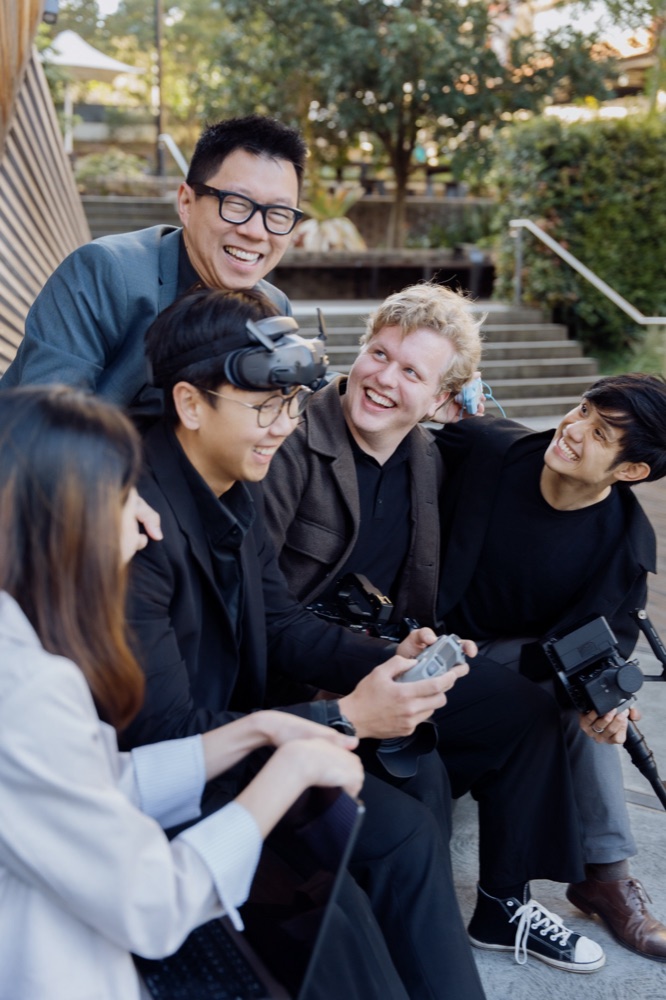 Frankie and the team sharing a laugh with their cameras and drone gear